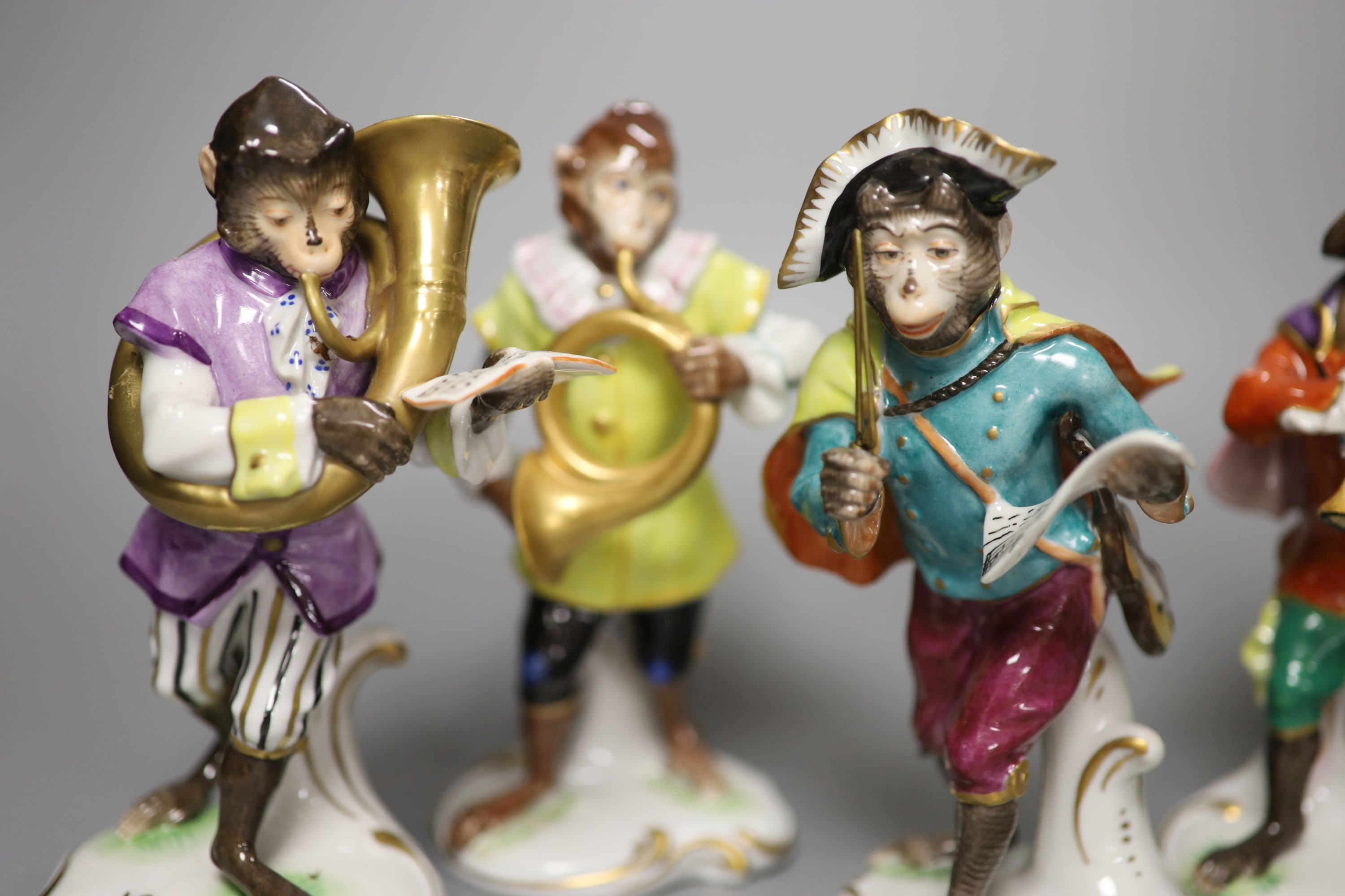 Seven German porcelain monkey band figures, height 15cm